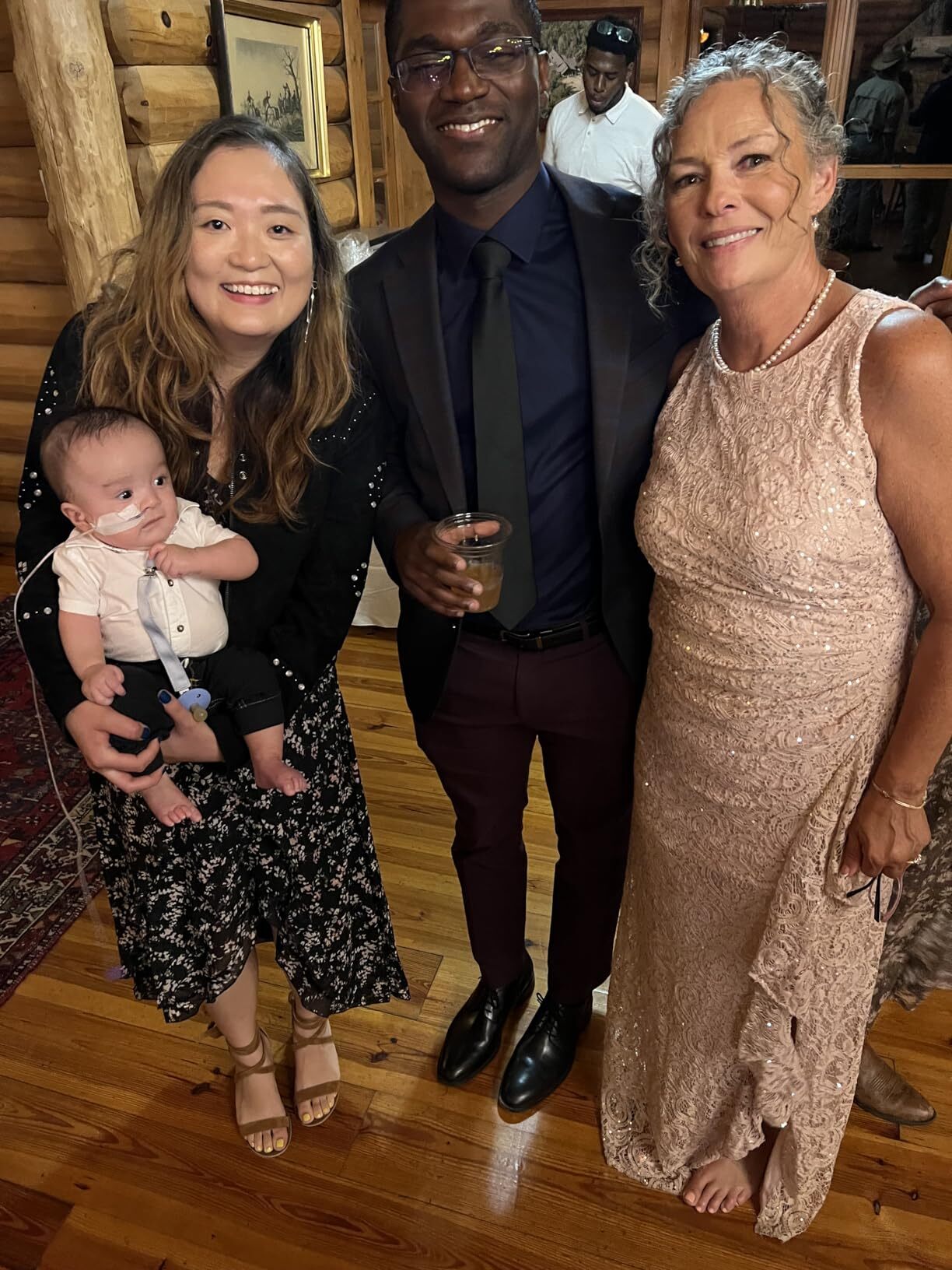 Mother of the bride celebrating with family at a rustic outdoor wedding venue