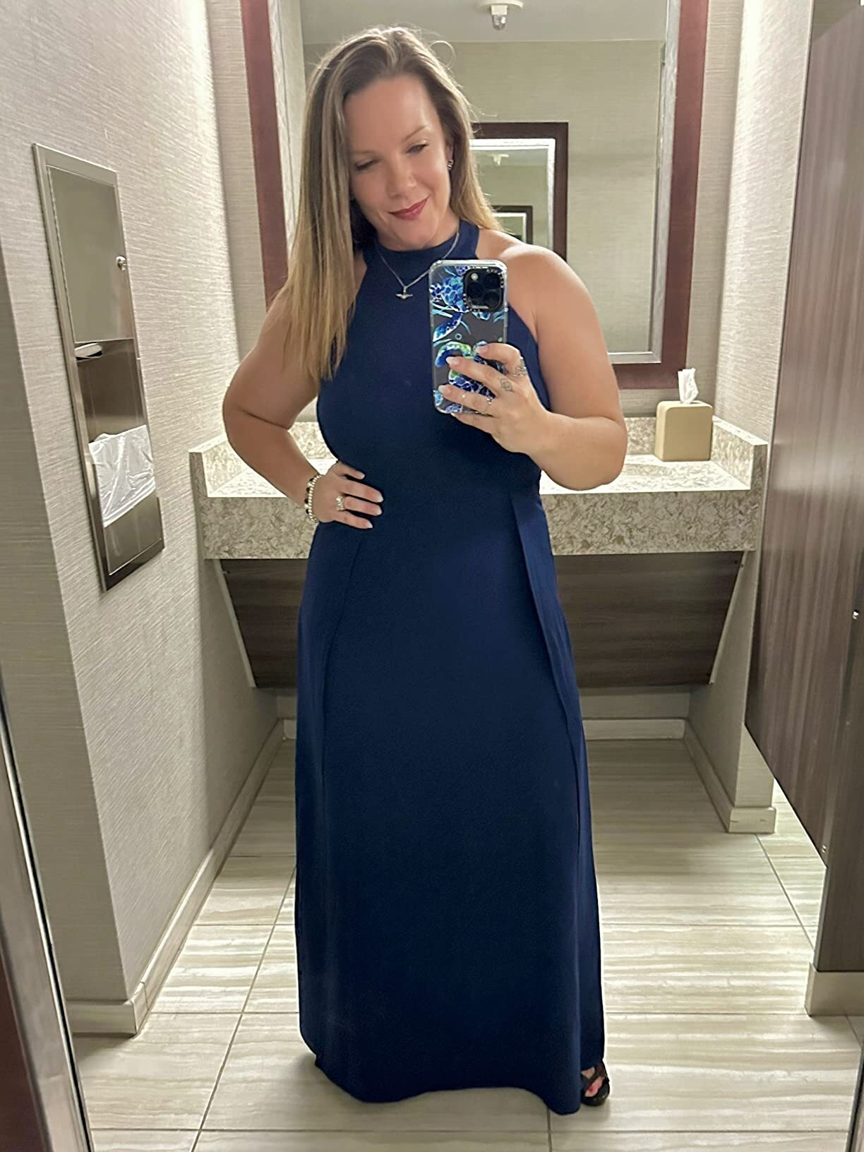 Woman wearing a navy halter maxi dress with high slit for a Marine Corps Ball